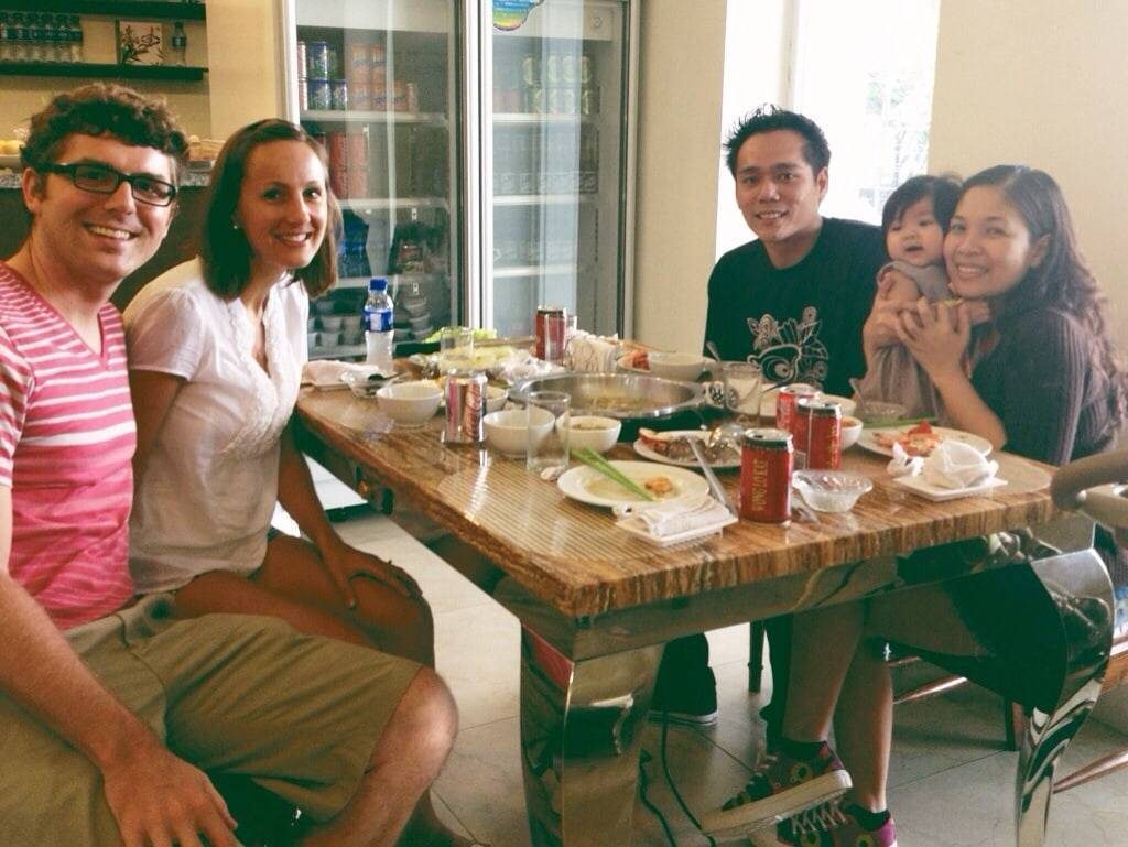 People sitting around a table eating.