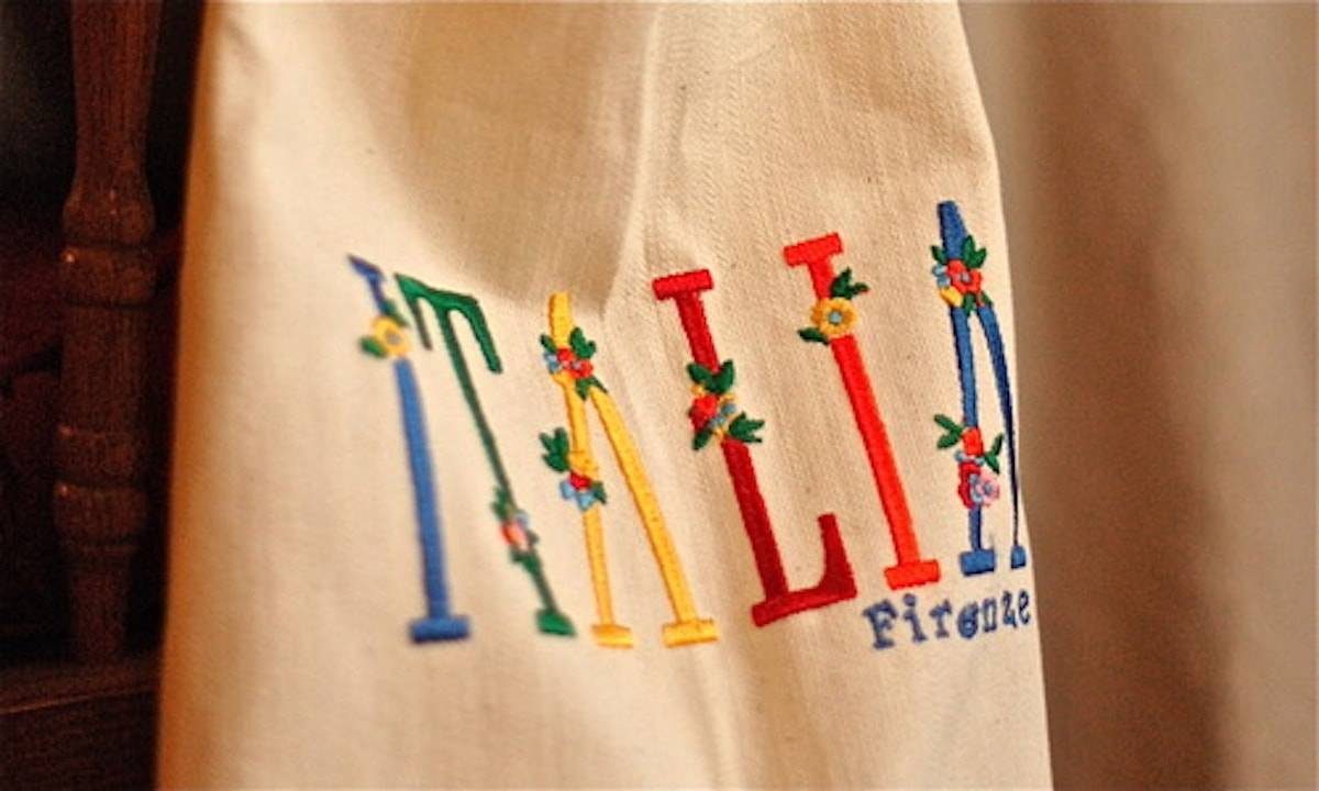Ivory apron with colorful "Italia" text.