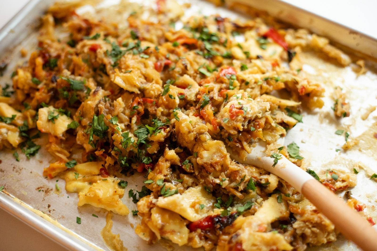 Scrambled eggs and veggies on a sheet pan.