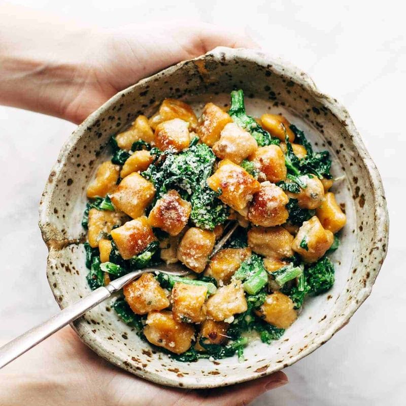 A picture of Sweet Potato Gnocchi with Broccoli Rabe and Garlic Sage Butter Sauce