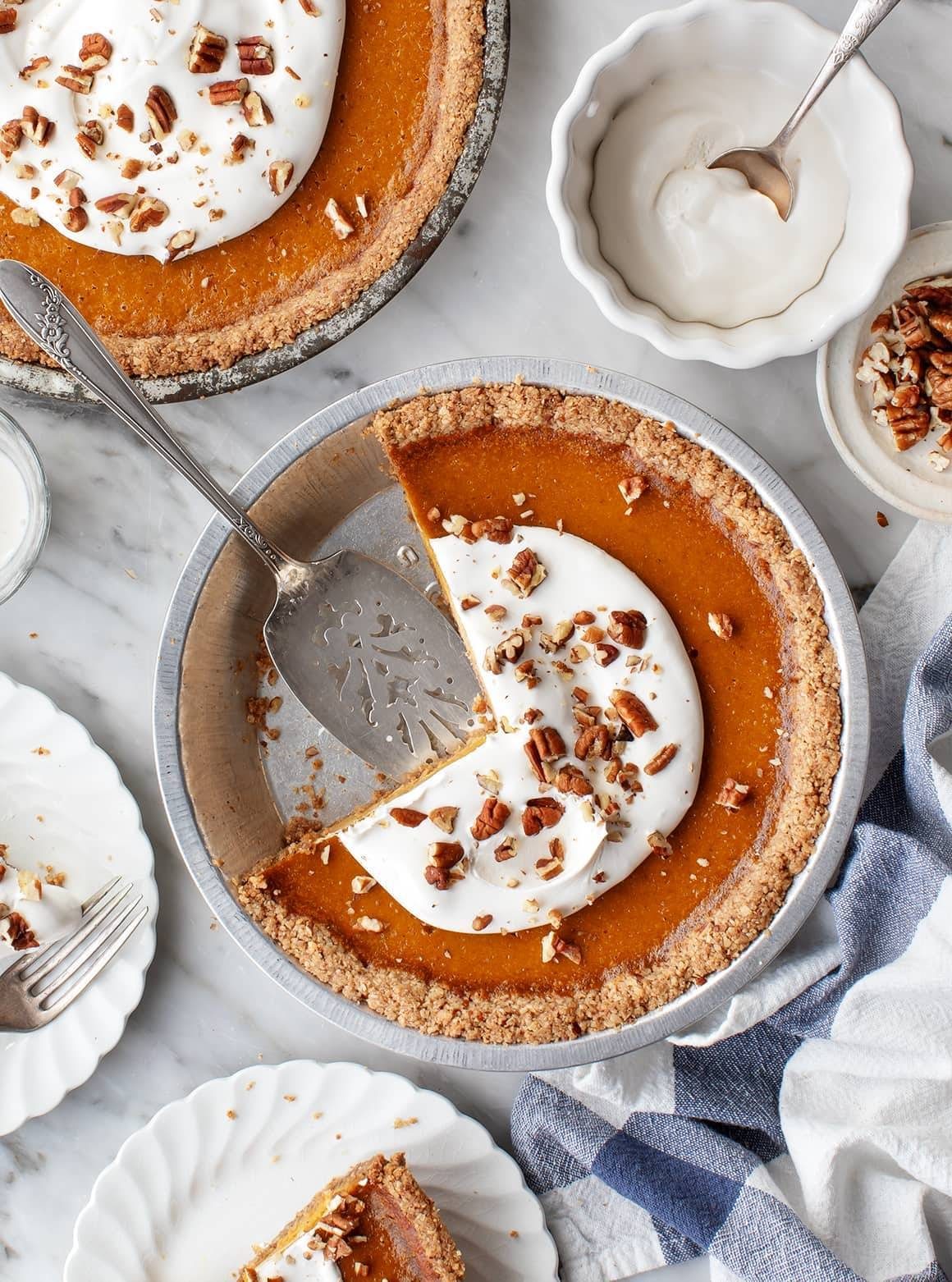 Best Pumpkin Pie missing pie pieces in a pie dish with a spatula