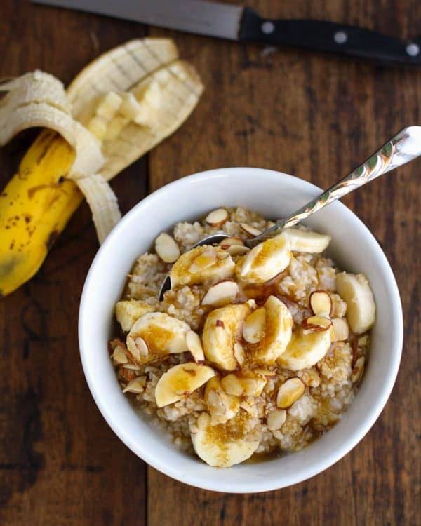 Steel cut oats with bananas in a white bowl.