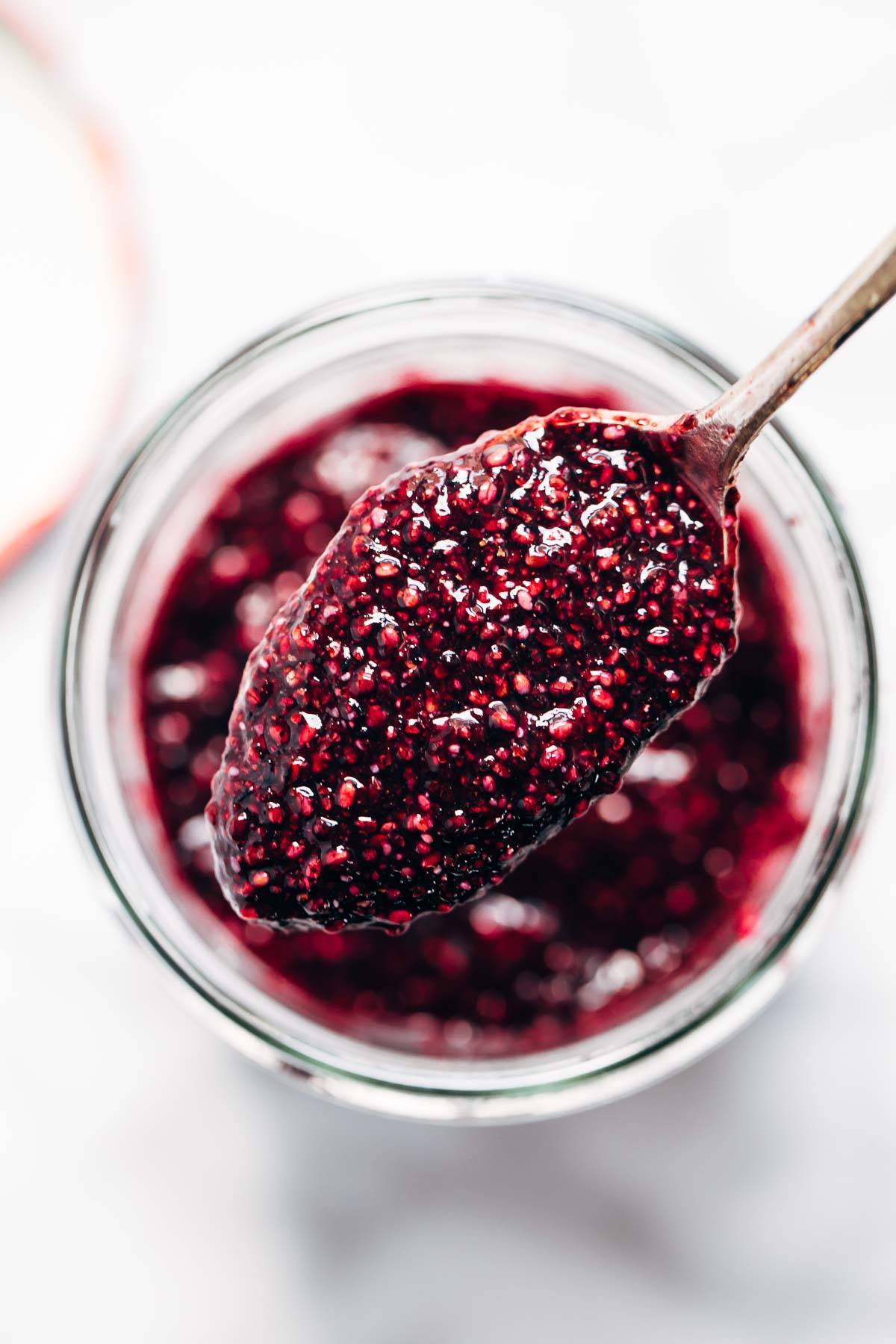 Berry jam in a jar and on a spoon.