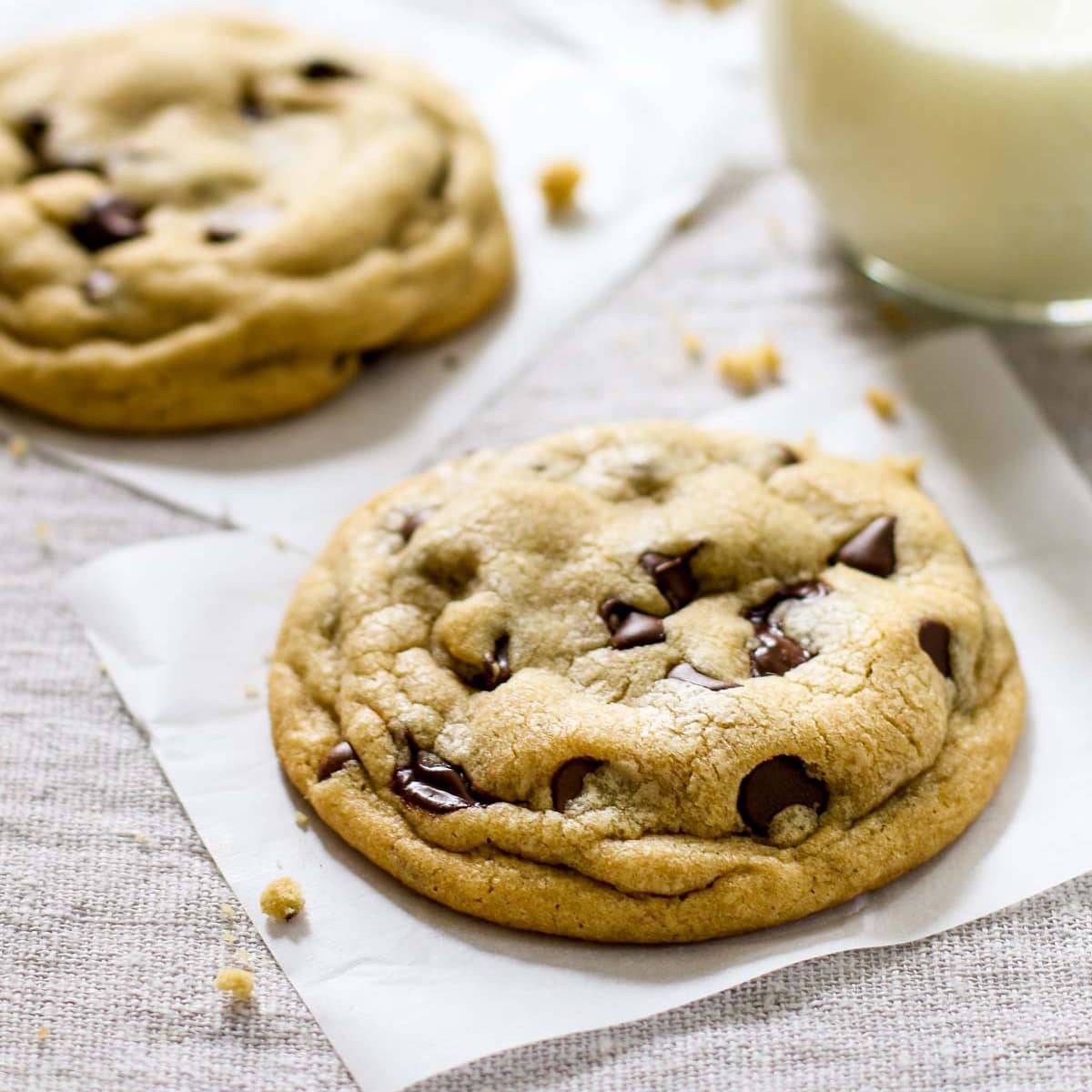 Soft chocolate chip cookies with a glass of milk.