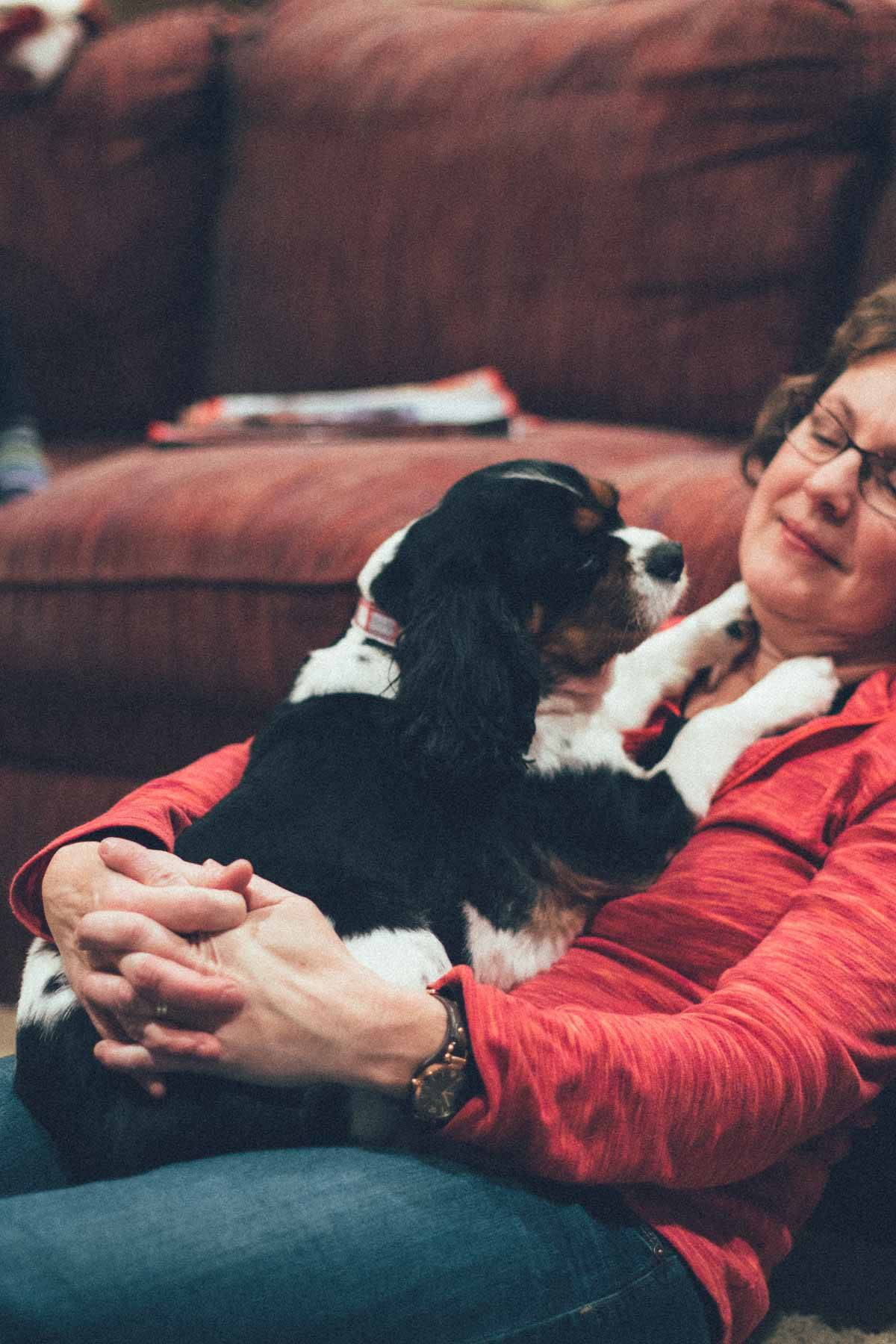 Woman holding a dog.
