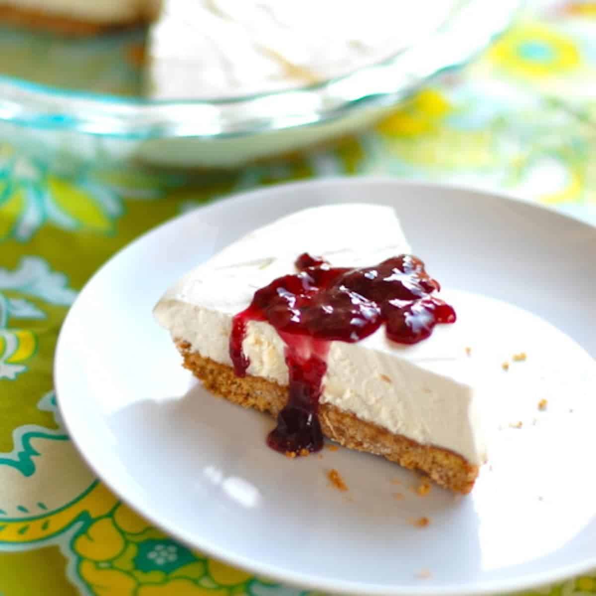 5-ingredient creamy lemon pie with a graham cracker crust on a white plate.