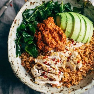 Kale and Chicken bowls with avocado and sauce.